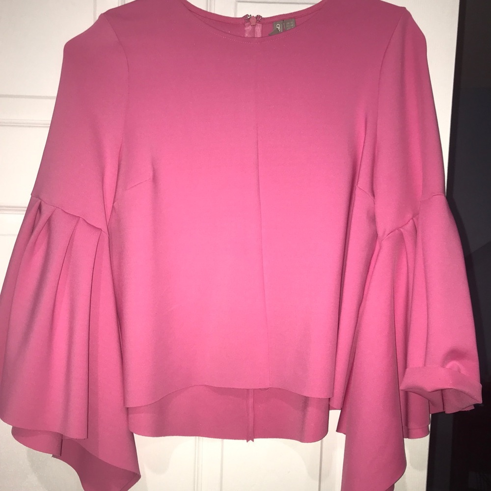 Hot pink top with exaggerated ruffle sleeves